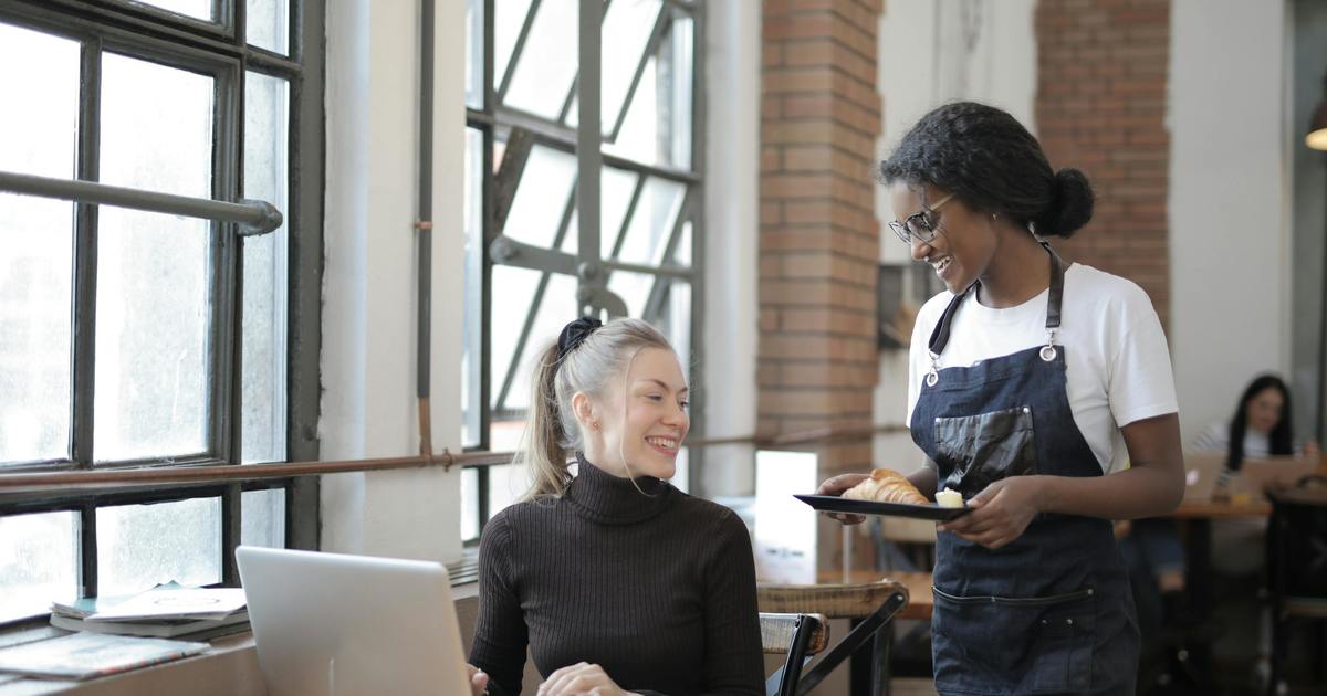 Writer working from a coffee shop with laptop