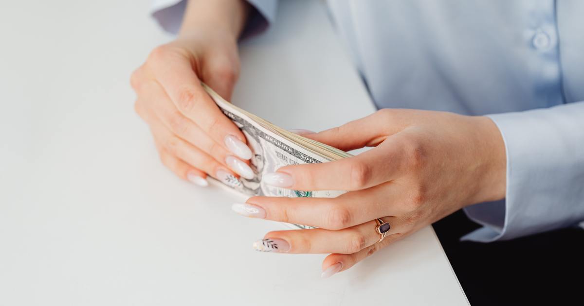 Writer holding cash in hands