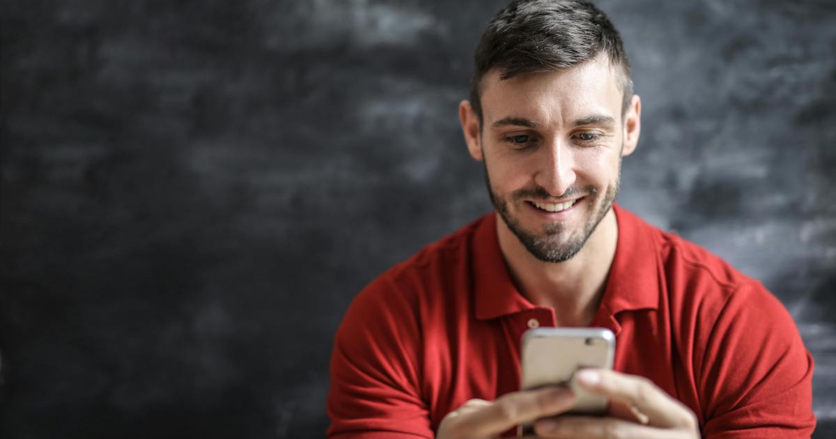 Writer smiling looking at phone