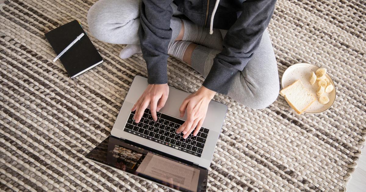 Writer sitting on floor with laptop