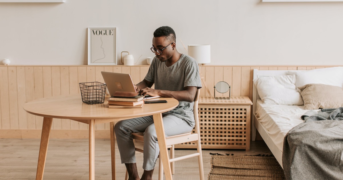 Writer typing on laptop at a table