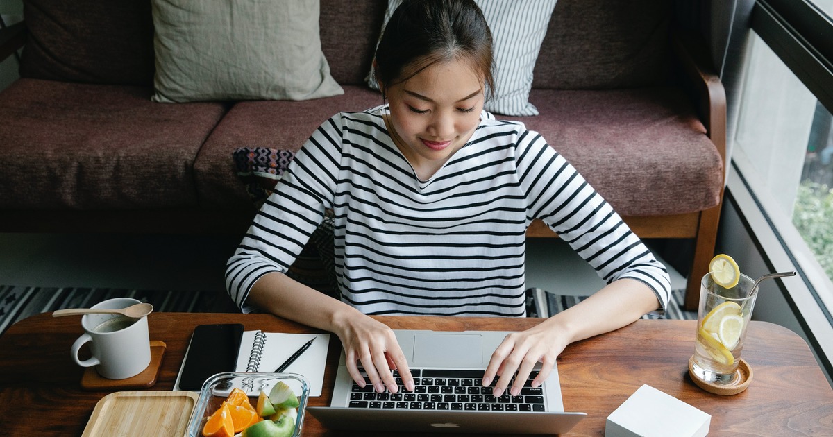 Woman typing on a laptop