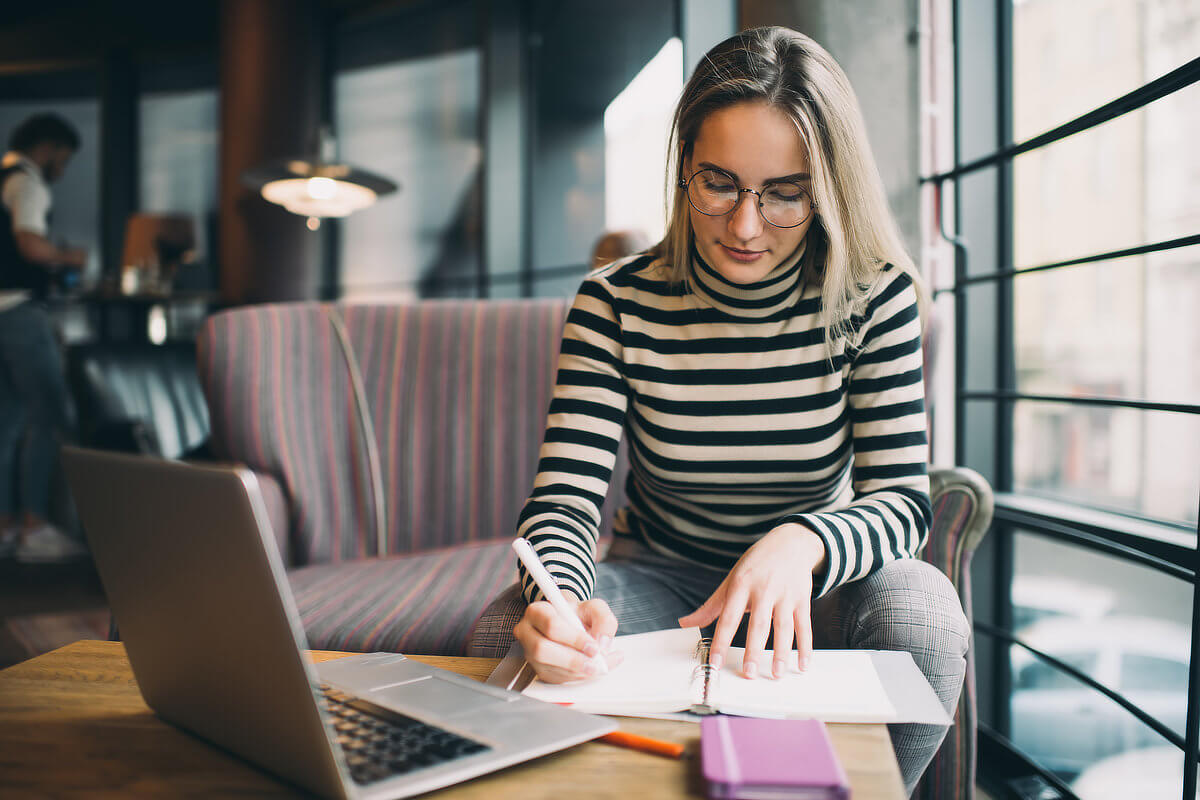 Woman Working in Cage on Laptop